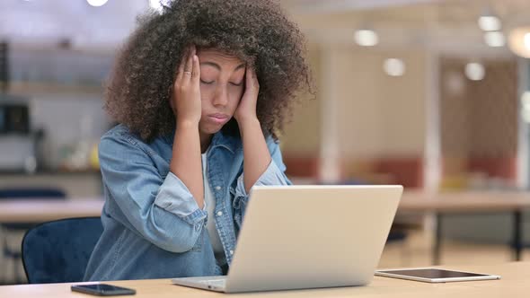Stressed African Woman Having Headache at Work 
