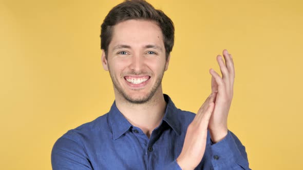 Applauding, Casual Young Man Clapping on Yellow Background