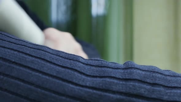 Man Cleaning a Sweater Sleeve with a Clothes Cleaning Roller