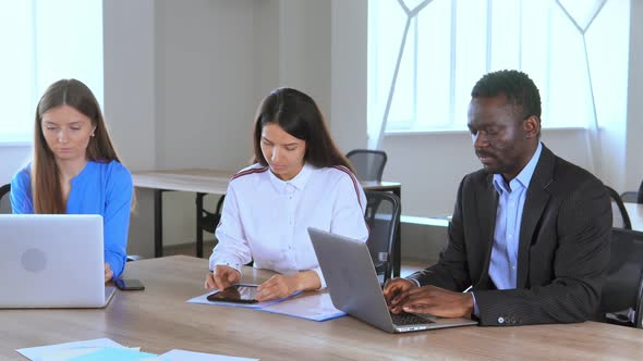 Multi Cultural Team of Employees Working at Workplace