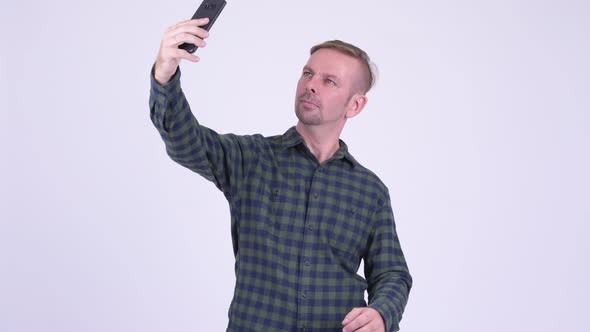 Portrait of Happy Blonde Hipster Man Taking Selfie with Phone