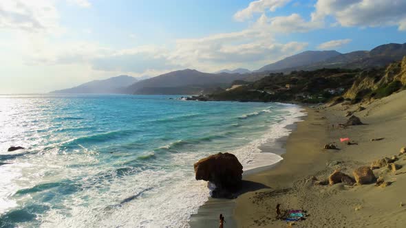 Scenic Aerial View of Young Active People on Ligres Beach at Sea in Crete