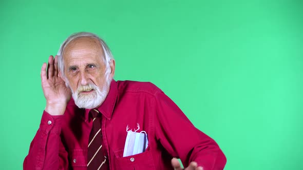 Portrait of Happy Old Aged Man 70s Holding Hand Near Ear Trying To Listen To News Expressing