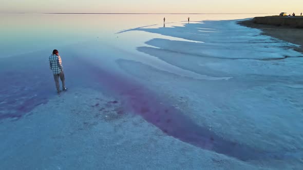 Drone View Young Woman Walks Along Salt Coast of Mineral Salt Lake