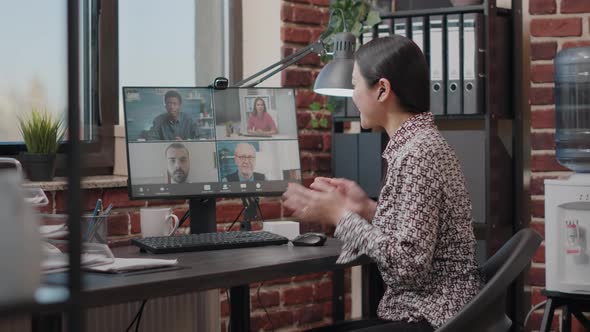 Business Woman Using Video Call to Talk to Colleagues About Project