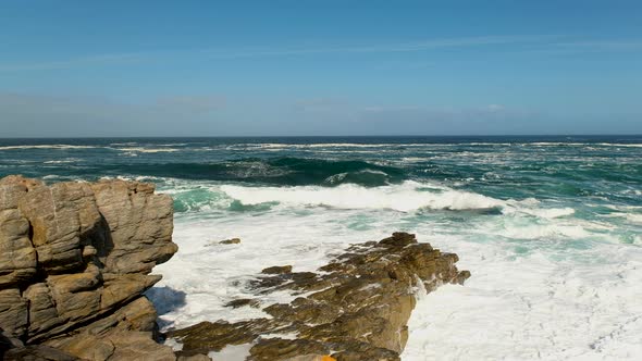 Wave crash into rocks with big white splash, rugged Atlantic coastline