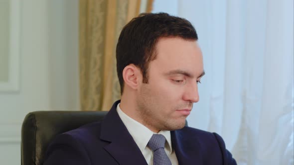 Pensive Businessman Working and Drinking Coffee