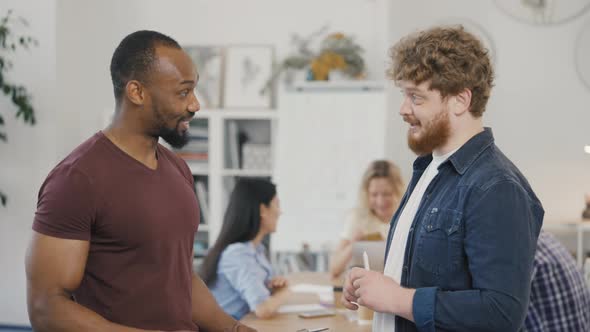 Two Colleagues Working Together Discussing Teamwork and Launching a New Startup Business Project