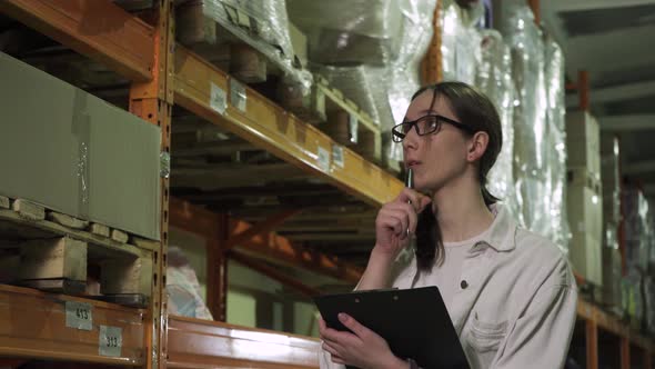 Closeup of a Young Employee with a Computer Tablet Working in the Warehouse