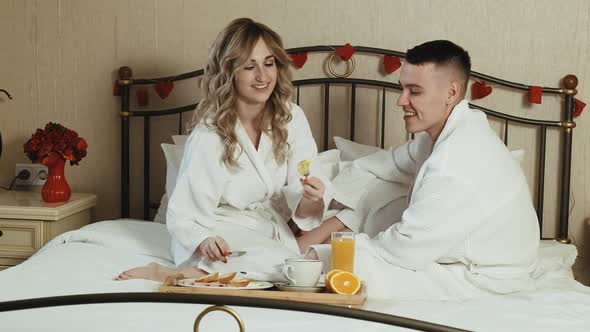 Young Couple Lovers Romantic Breakfast in Bed