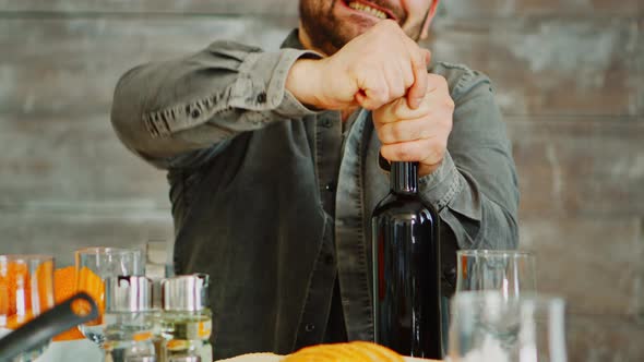 Close Up Shot of Man Opening a Bottle of Red Wine