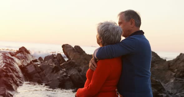 Senior couple embracing on beach 4k
