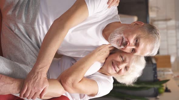 Sporty Elderly Couple Relaxing on the Floor After Yoga and Fitness Classes at Home