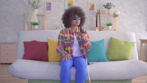 African American Woman with an Afro Hairstyle Visually Impaired Uses Voice Assistant on Your