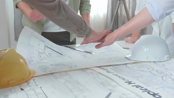 Close Up Of Group Of Asian Engineers Create Harmony With Hands On Top Of Each Other At The Office