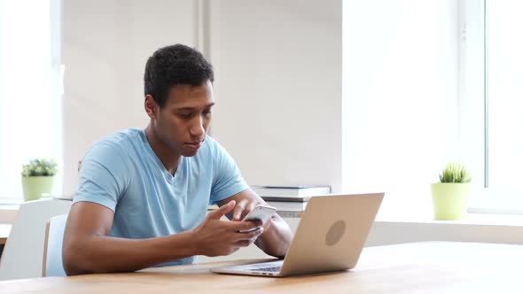 Young Black Man Using Smartphone, Online Browsing