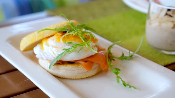 Traditional English Breakfast with Eggs Benedict in Restaurant