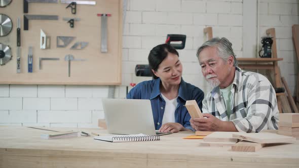 Senior man and woman design furniture