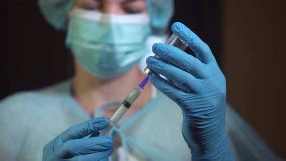 Doctor Hands in Gloves Filling Syringe with Injection Liquid  Vaccine