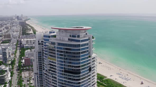 Drone Flying Around a Residential Skyscraper on the Ocean Coast, South, Miami Beach alt