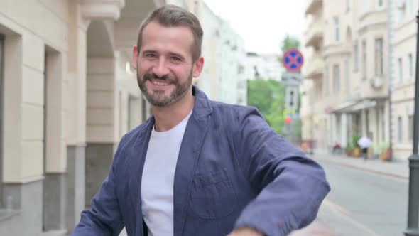 Close Up of Mature Adult Man Dancing While Walking Down the Street