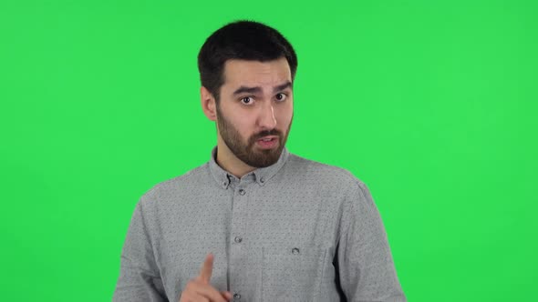 Portrait of Brunette Guy Is Talking About Something Then Making a Hush Gesture, Secret. Green Screen