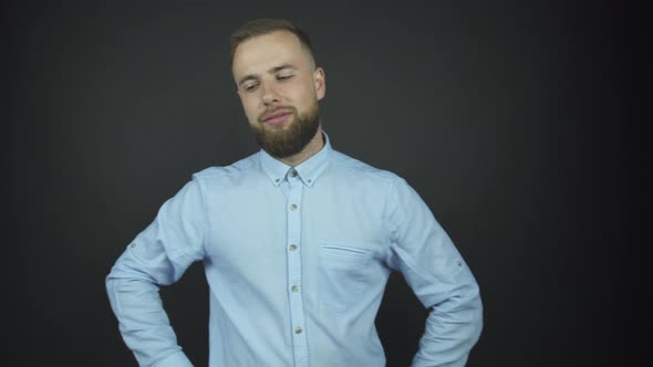 Man with Beard Poses for Photo Shoot Holding Hands on Hips