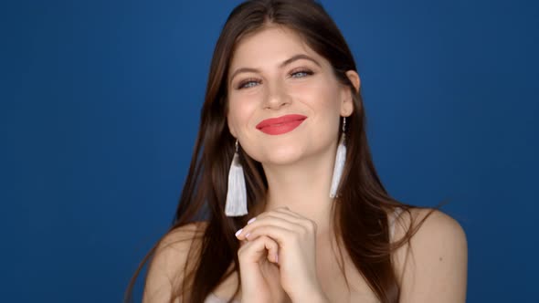 Portrait of a Girl in the Studio on a Blue Background