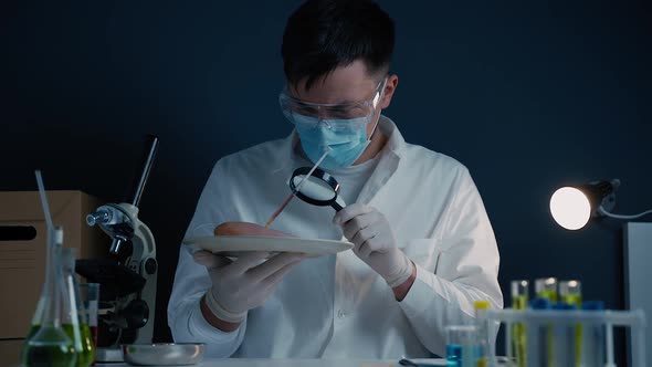 Laboratory Assistant with Magnifying Glass Examining Raw Meat