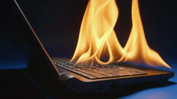 Laptop Flaming On A Table alt