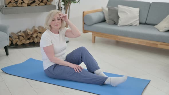 Senior Old Woman Feeling Tired While Doing Yoga at Home