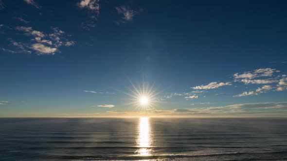 Starburst Sun Rising Over The Ocean