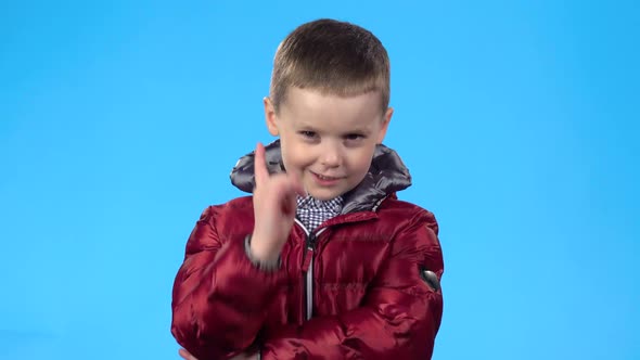 Child Looking at Camera and Threatening with Finger To Someone.