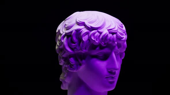 Plaster Head Sculpture Apollonian in Purple Neon Light Closeup