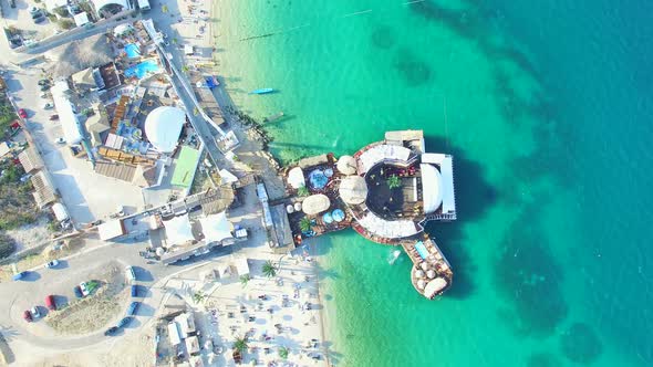 Aerial view of people partying in club on the sea water, Pag island