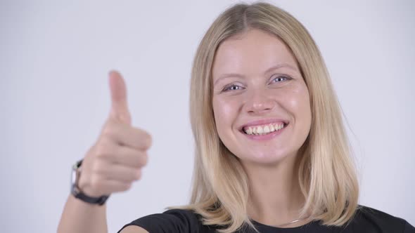 Face of Young Happy Blonde Woman Giving Thumbs Up