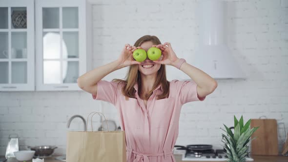 Woman with fresh apple eyes. Portrait of happy woman closing eyes by apples