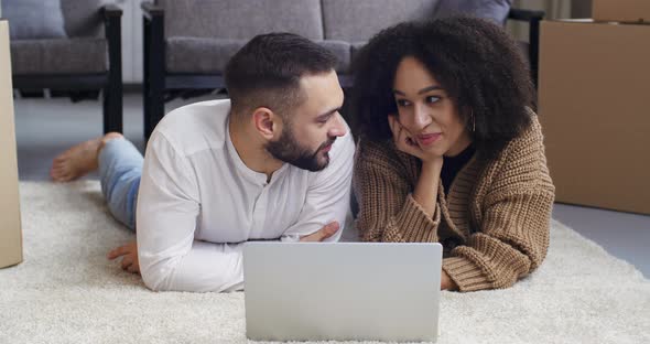 Multiethnic Couple African American Girl Wife and Caucasian Bearded Young Husband Man Lying on Floor