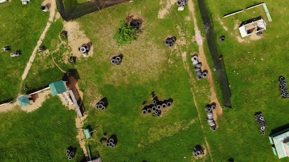 Paintball Players Prepare for Game on Green Battlefield