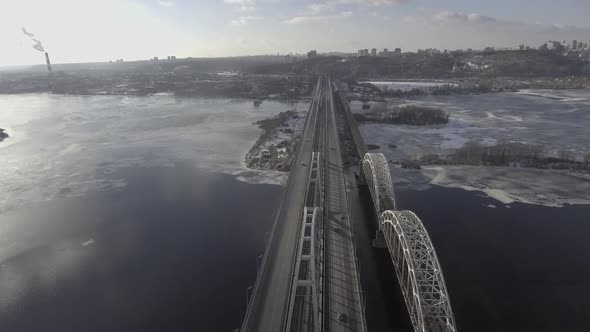 Flying Over the Railway Bridge, at the Bottom of the Car Ride, the River Was Frozen