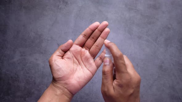 Close Up of Young Man Hand Using Hand Sanitizer Spray.