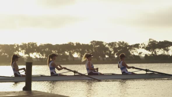 Female rowing team training on a river