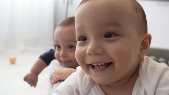 Happy Asian Twins Relaxing in Ball Pool