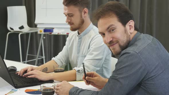 Mature Businessman Smiling To the Camera While Working at the Office