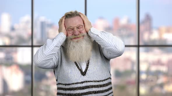 Depressed Senior Man on Windows Background