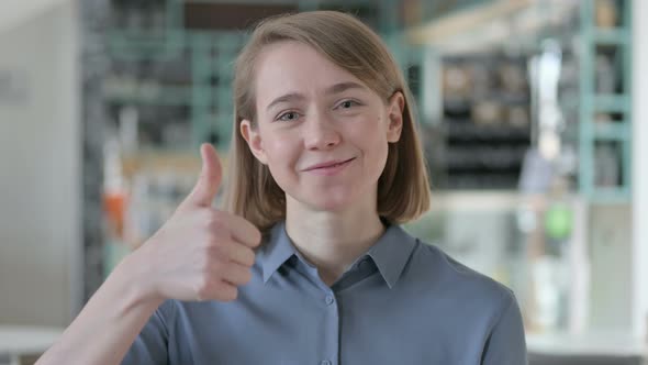 Portrait of Young Woman Showing Thumbs Up Sign