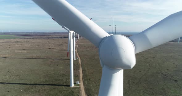 Close up view of a wind turbine. Windmill for electric power production. Green energy.