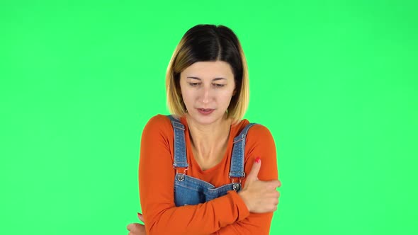 Beautiful Sweet Girl Froze and Trying To Keep Warm Against Green Screen