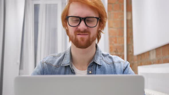 Man Working on Laptop and Reacting to Loss