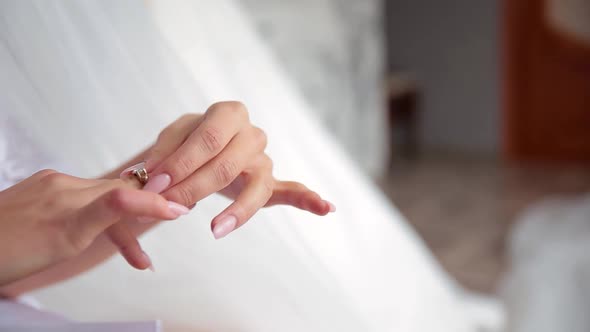 Beautiful Young Woman Putting Ring on Her Finger.